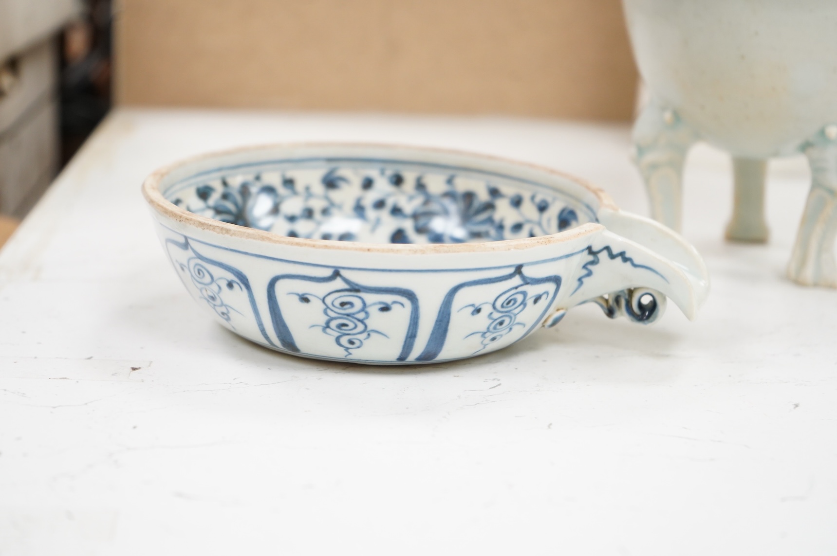 A Chinese three footed censer and a blue and white pouring bowl, largest 15cm high